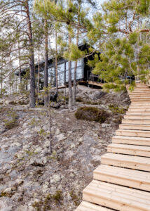Lake front log villa stairs Finland Honkarakenne photography interiors
